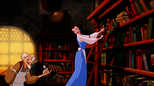gif of Belle from Beauty in the Beast swinging along a bookshelf in a library