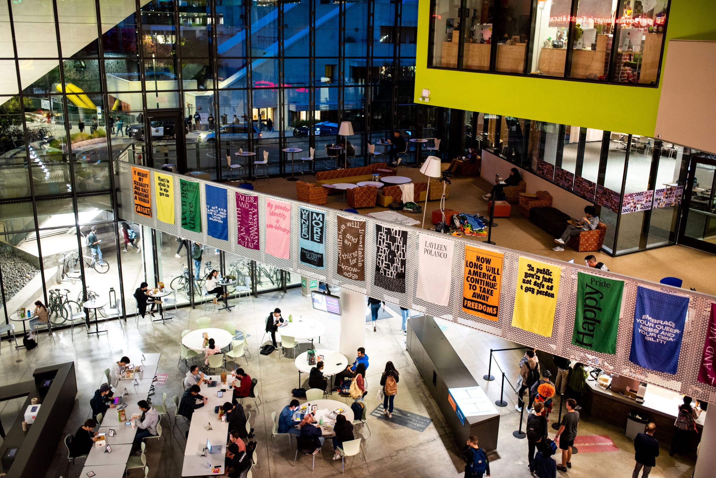 large, colorful student union filled with students at night