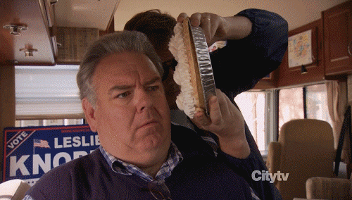 gif of Andy slowly placing a pie on the side of Jerry's face from Parks and Recreation