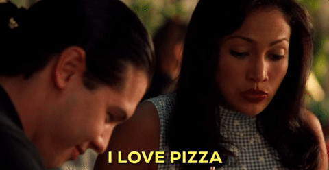 gif of a woman saying 'I love pizza' while eating one