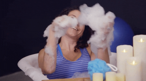 Person playing with bubbles in a bathtub gif