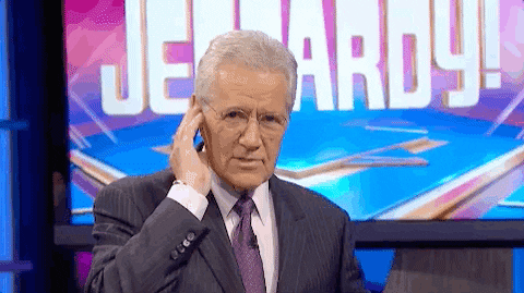 gif of Alec Trebek giving a thumbs up to camera while on the Jeopardy set