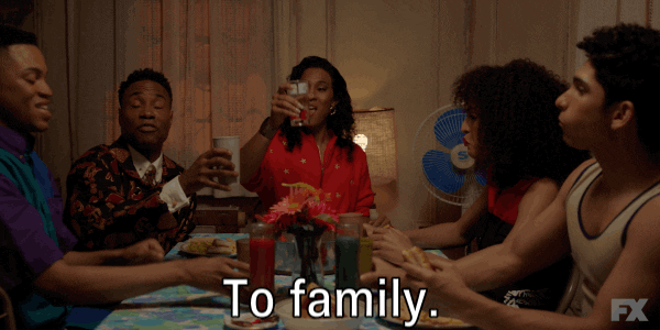 gif of the cast of Pose toasting each other over dinner and saying 'to family'