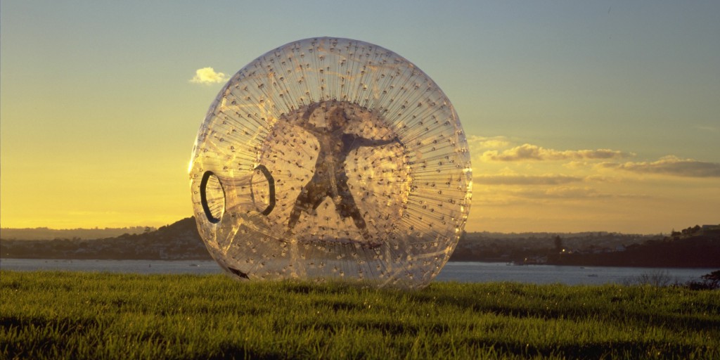 drawing of a person zorbing, inside a transparent orb