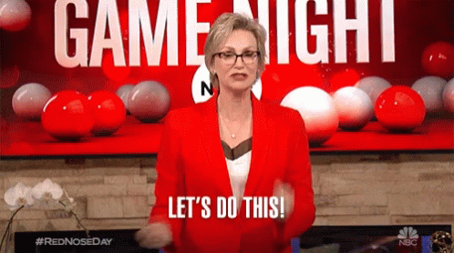 gif of Jane Lynch saying 'let's do this!' as she stays in front of a 'game night' sign